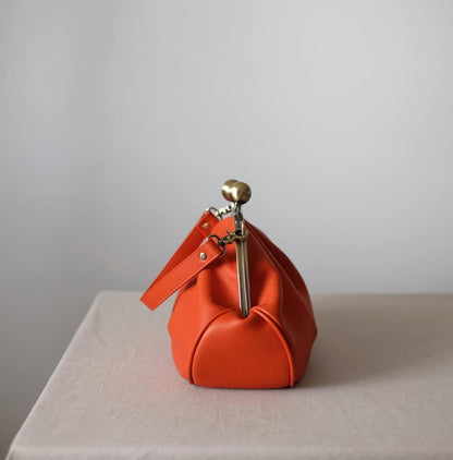 Medium version of a bag with a clasp,orange clutchbag