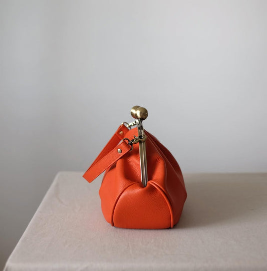 Medium version of a bag with a clasp,orange clutchbag
