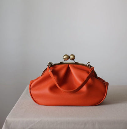 Medium version of a bag with a clasp,orange clutchbag