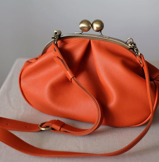 Medium version of a bag with a clasp,orange clutchbag